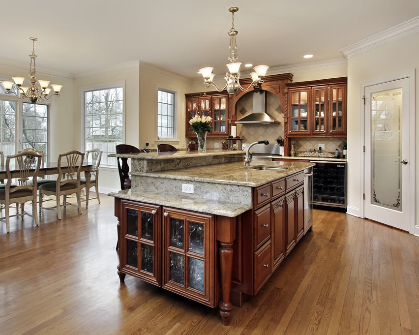 Traditional island with paneled walnut cabinets 