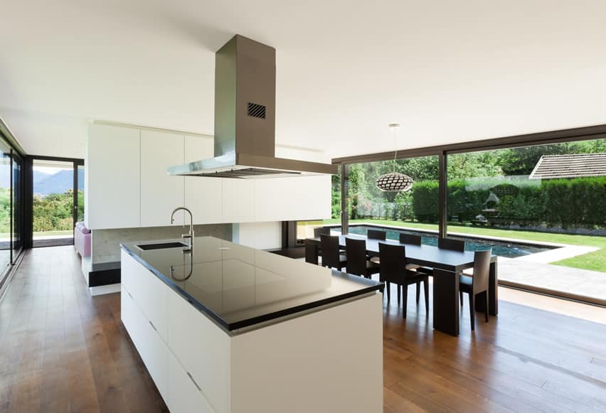 Black and white kitchen with stainless hood