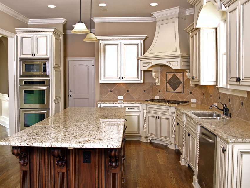 Carved wood kitchen island with light granite counter
