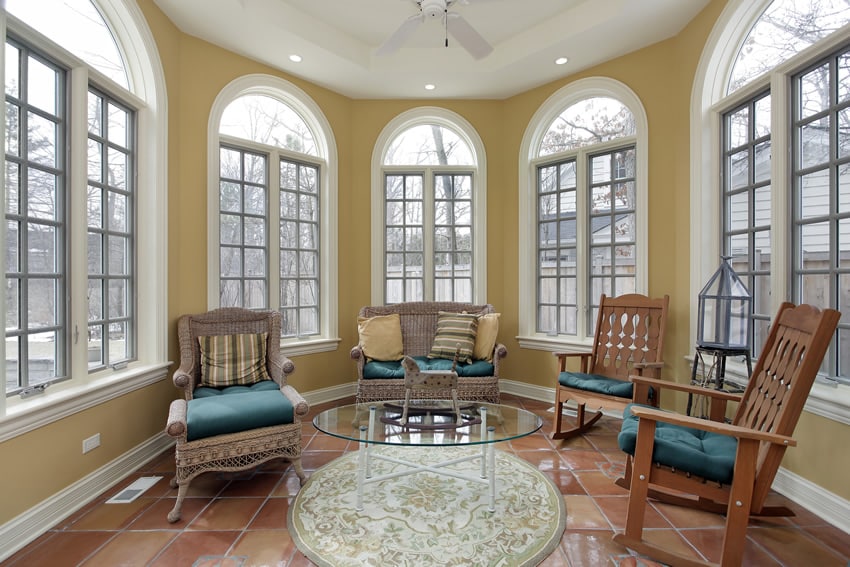 Circular shaped sunroom in yellow with tile floor