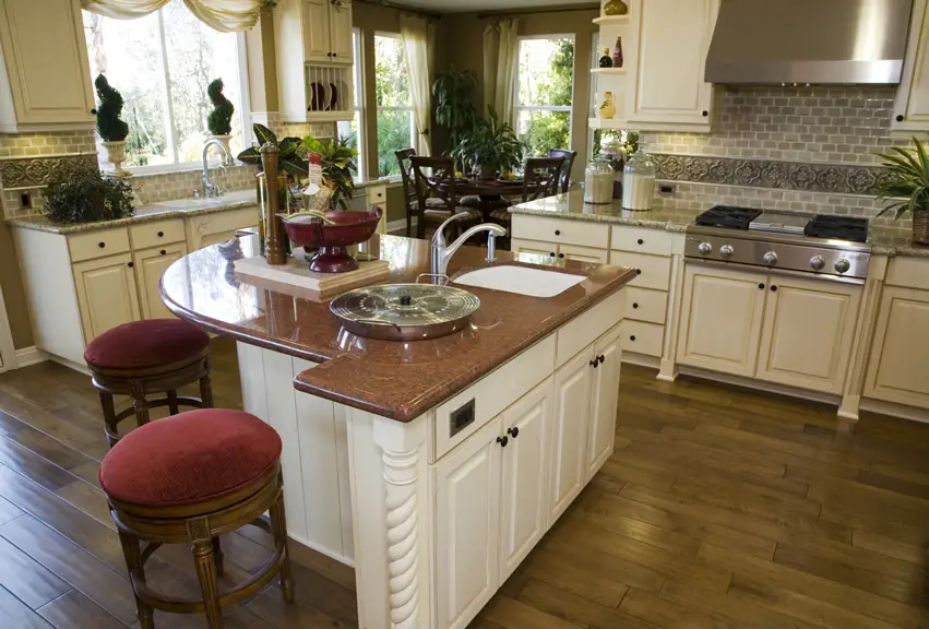 Imperial red granite island, red counter chairs, and grey brick backsplash