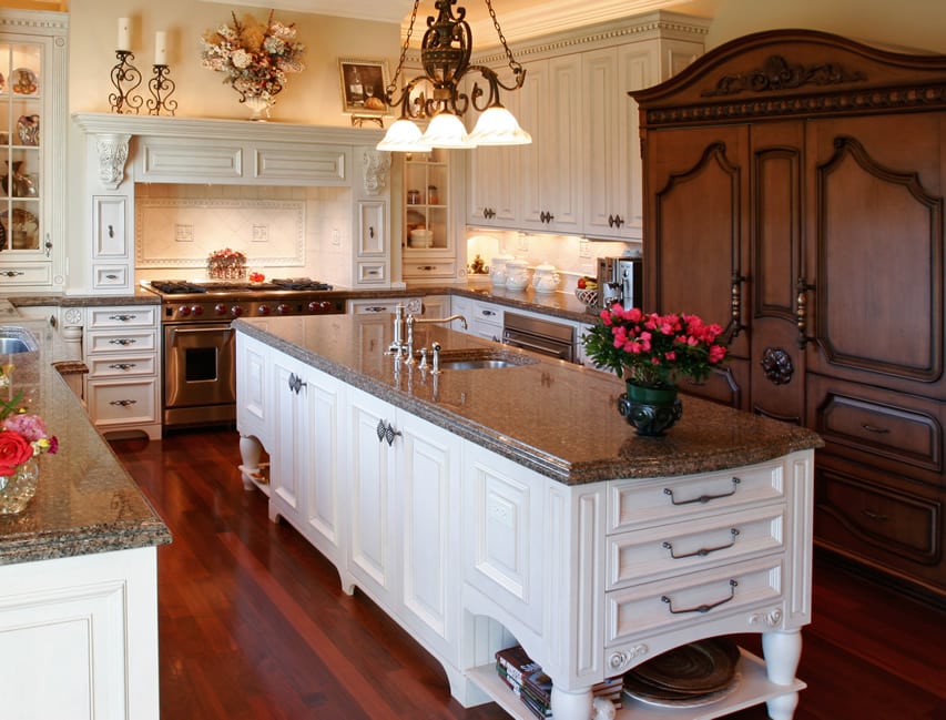 Custom white cabinet kitchen island with granite counter