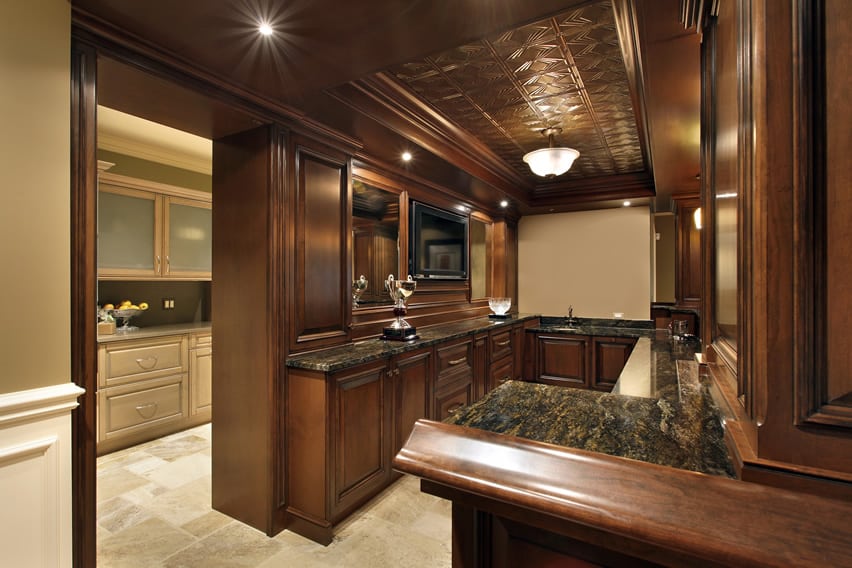 Custom wood bar area with dark cabinets and granite countertops
