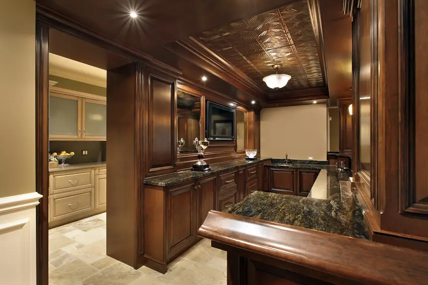 Ceiling with panels made of oakwood in bar space with built in appliances