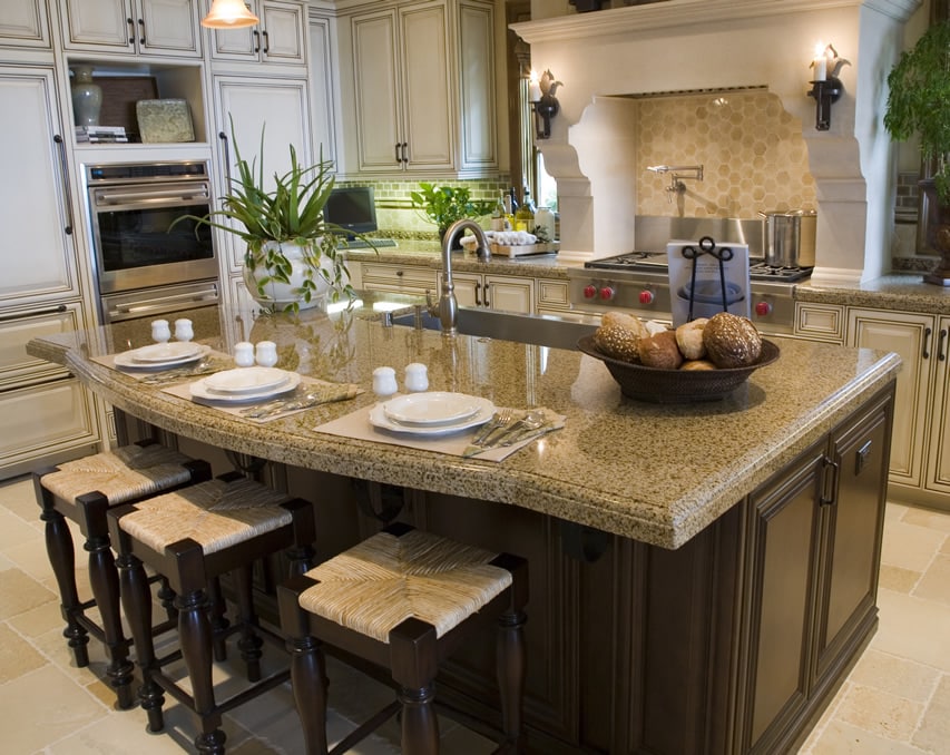 Eat in kitchen island with tan granite counters