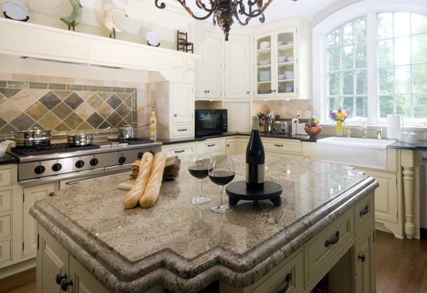 Black granite countertop and off white cabinets