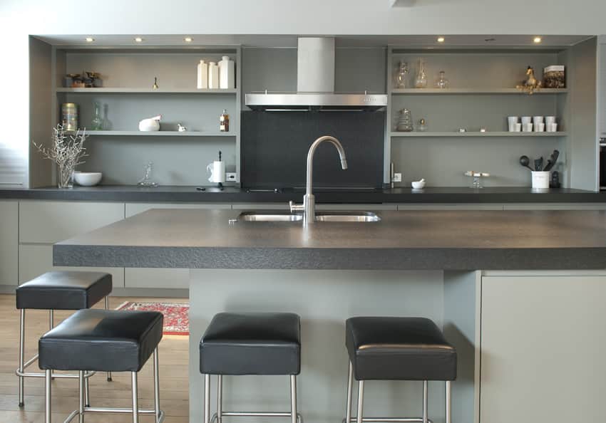 Gray counter kitchen island with leather bar stools