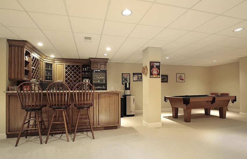 Home bar in basement with pool table