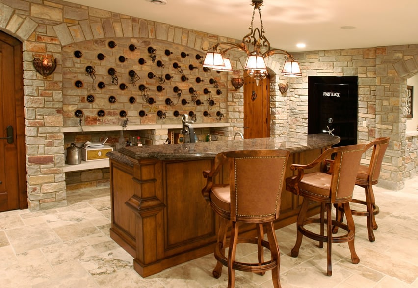 Home bar in basement with stone wine storage