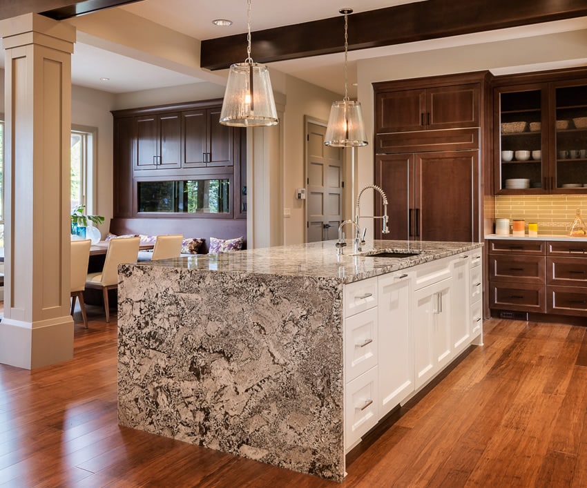Waterfall kitchen island with white base cabinet and dark wood main cabinets