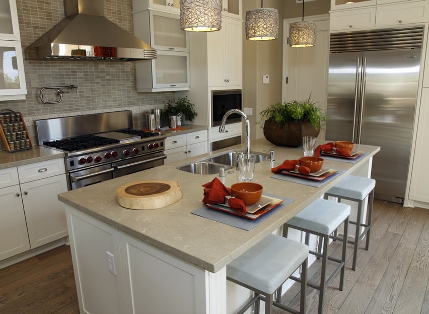 Quartz Countertop And Two Pendant Lights Over The Kitchen Island kitchen island with sink and light quartz counter top