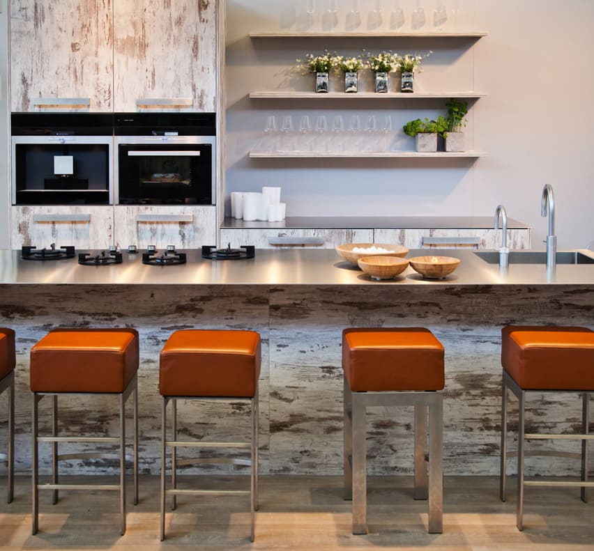 Long modern kitchen island with orange barstools