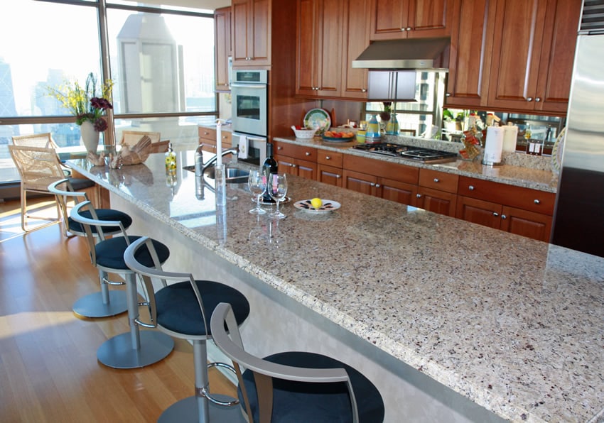 Extra long rectangular kitchen island with granite and barstools