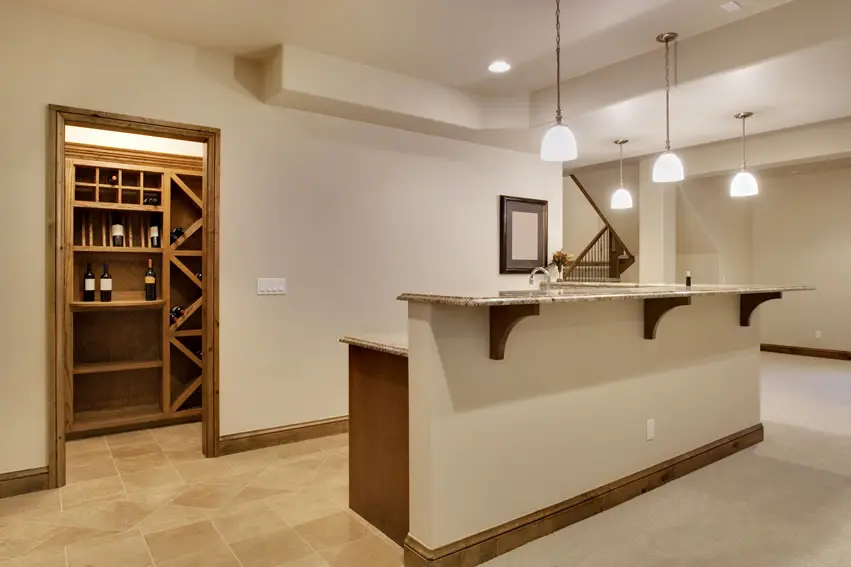 Basement with bar, oak counter and pantry with wine shelving