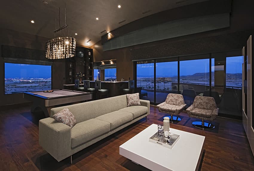 Luxury modern bar game room with wood floors and city views
