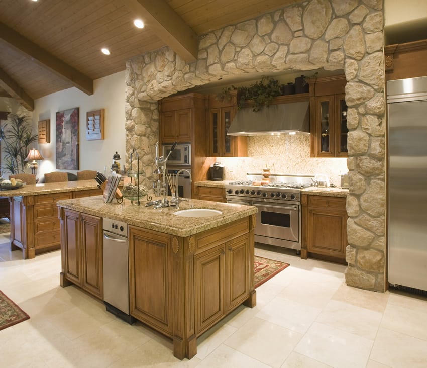 Stone accent wall, oak cabinets and granite counter