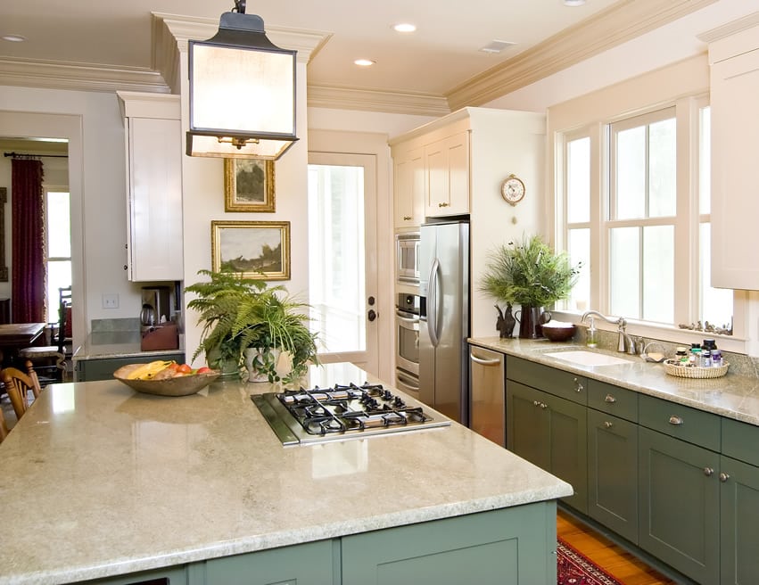Painted green kitchen island with green lower and white upper cabinets