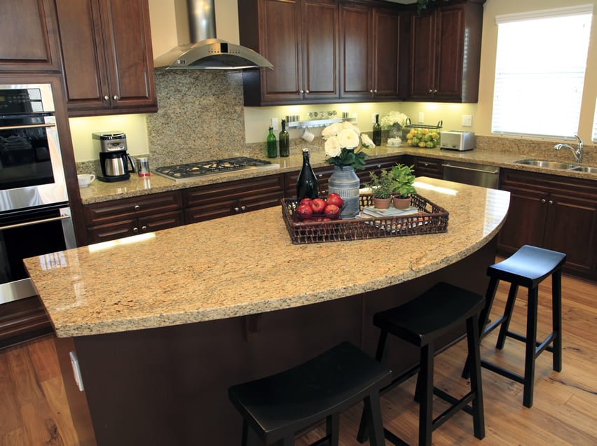 Countertops in beige granite and wooden tray with apples