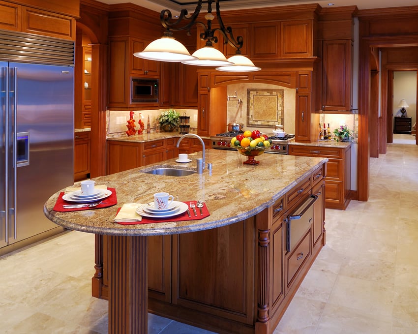 L-shaped kitchen with rounded granite island