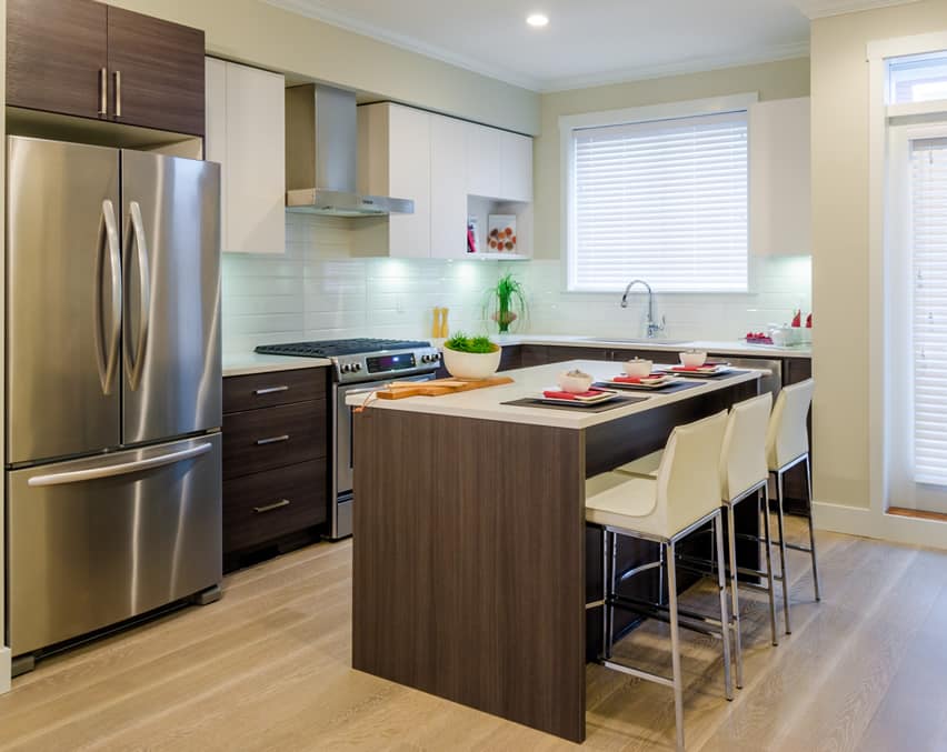 Small modern kitchen with island and white backsplash