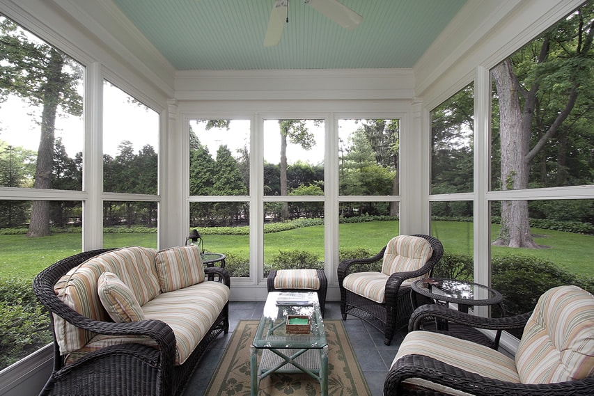 Sun room with many windows and garden view