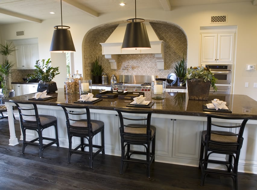 Extra large island with seating and white custom oven hood