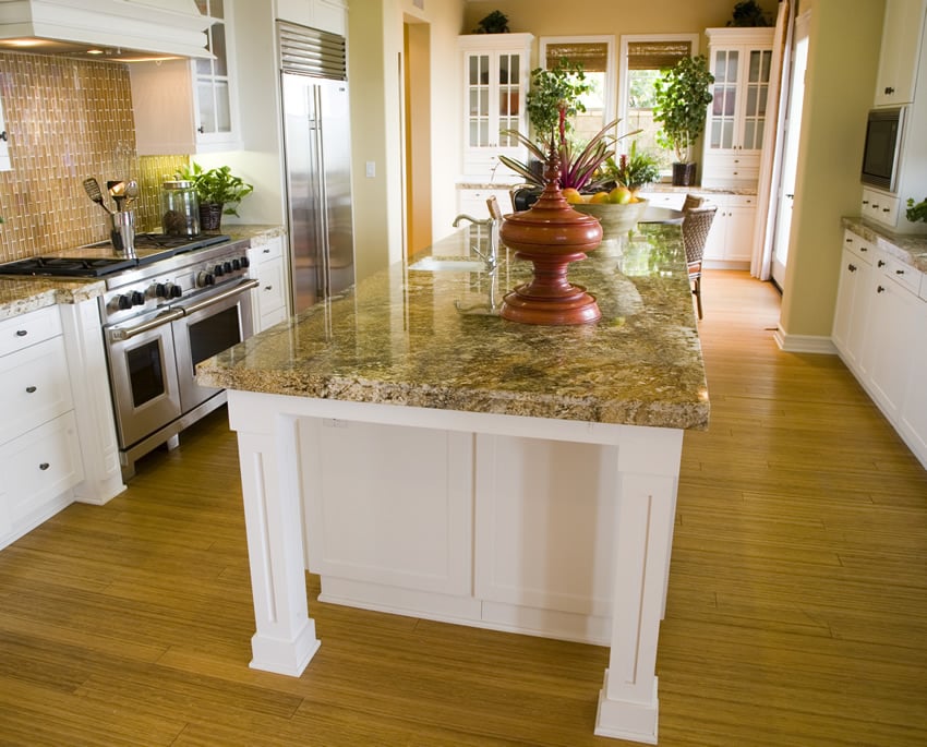 White kitchen island with full slab yellow granite counter top