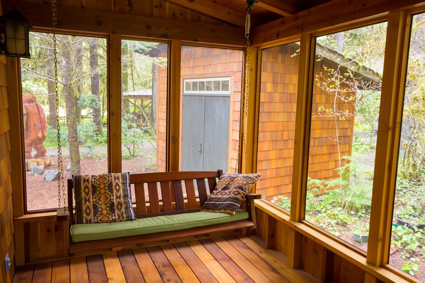 Wood sunroom with bench swing