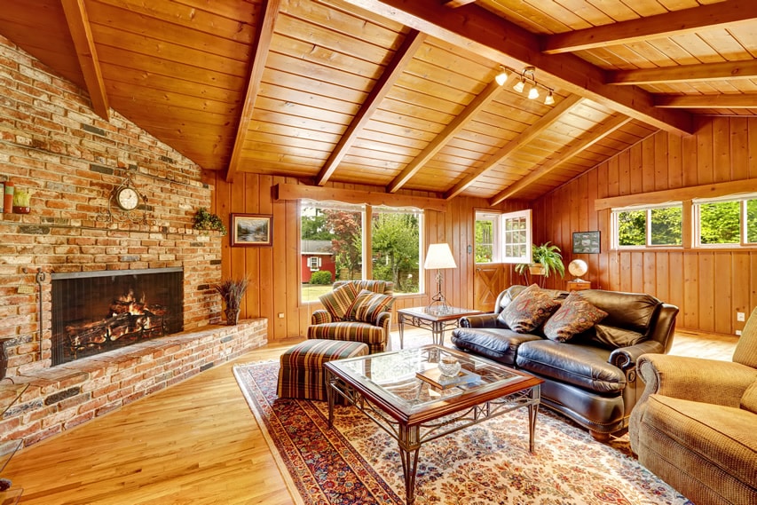 Wood sunroom with brick fireplace
