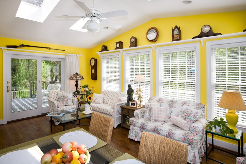 Yellow sunroom with antique decor