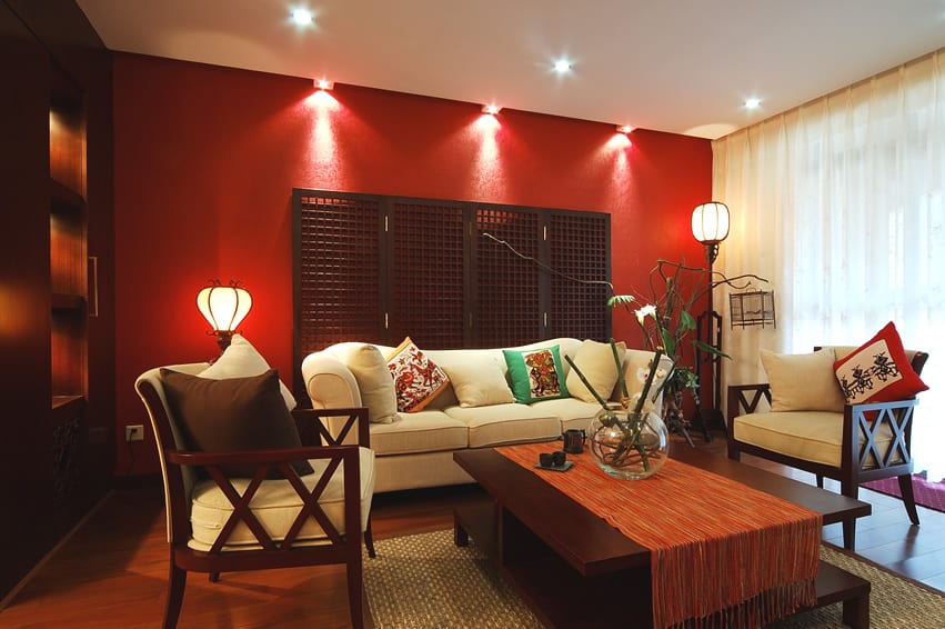 room with wood divider, center table, alcove walls and red wall