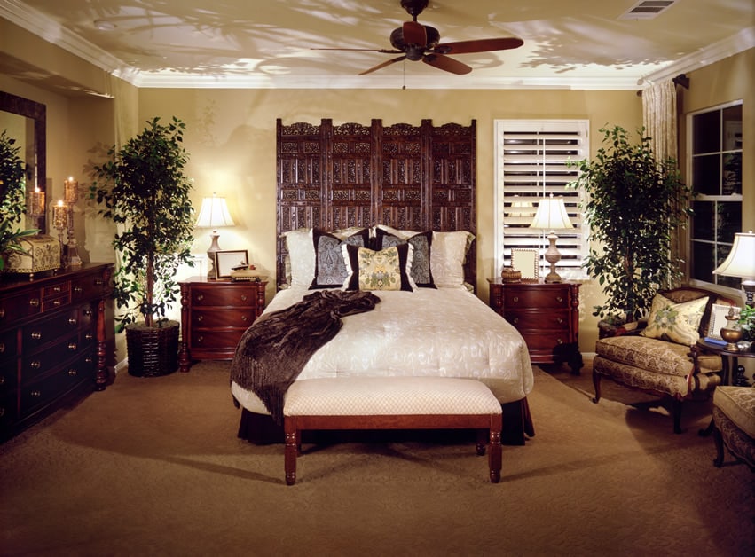 Bedroom with brown carpet white bedding