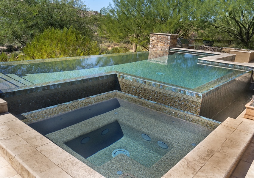 Lagoon style spa connected to swimming pool