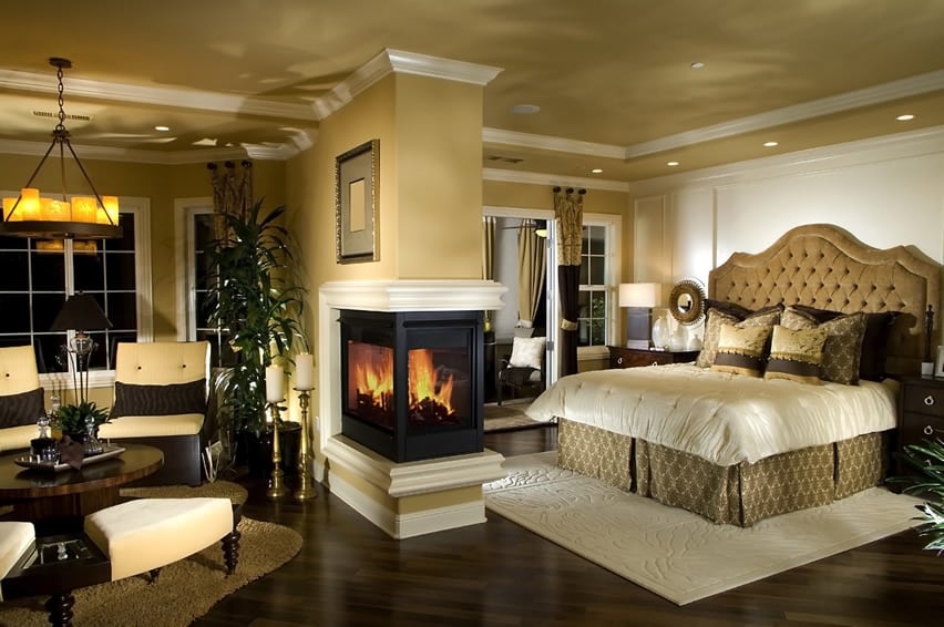 Designer master bedroom with fireplace in center