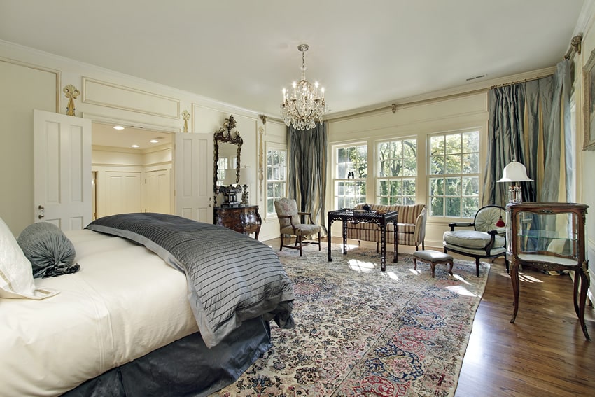 Elegant bedroom with sitting area and hardwood floors