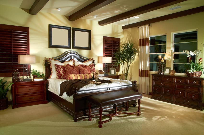 Elegantly decorated bedroom with wood shutters and furniture