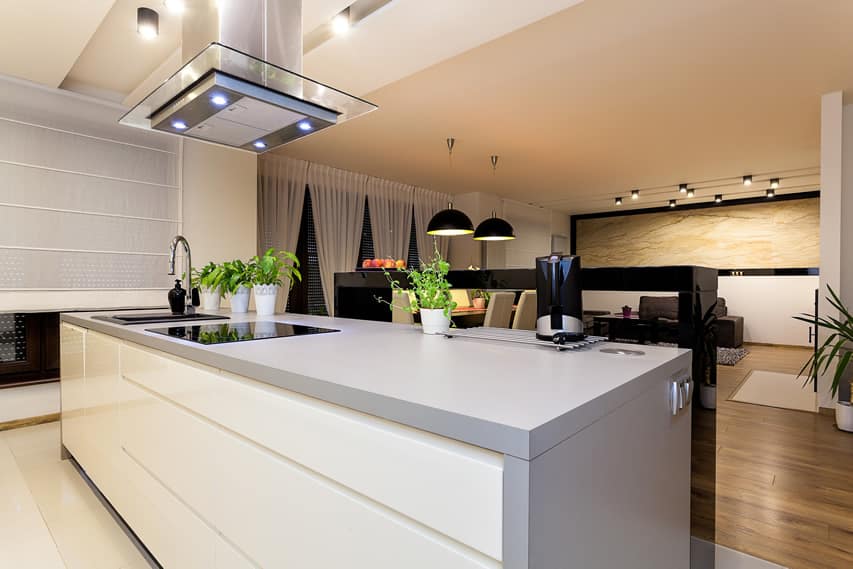 Gray island, black breakfast bar and pendant lights