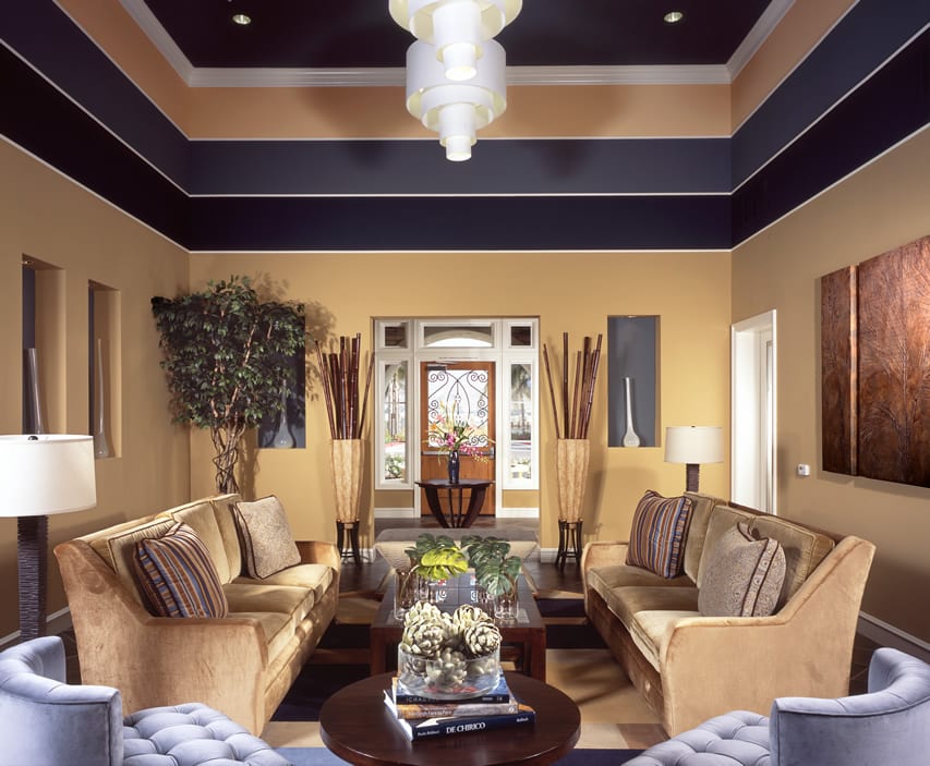 Room with multi color ceiling, wall alcoves, and sofa with tufted seats