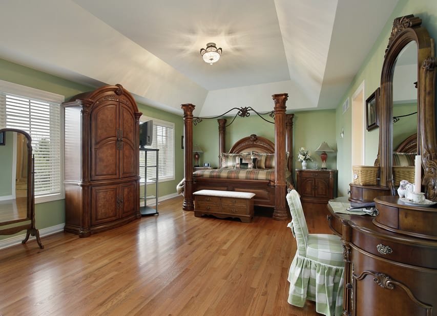 Large bedroom with beautiful wood furniture pillar bed