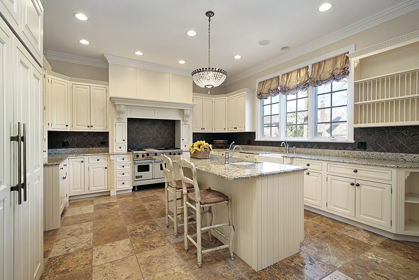 Large elegant kitchen white cabinets light granite