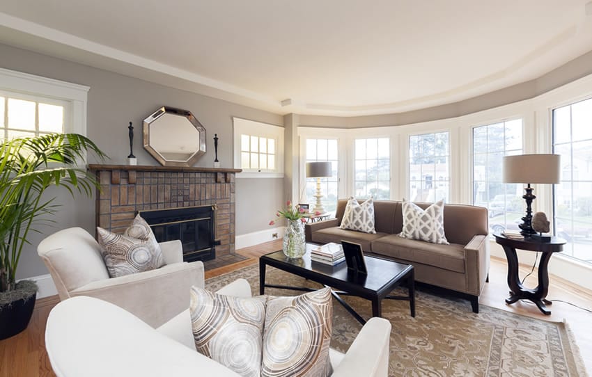 Room with picture windows and brick fireplace