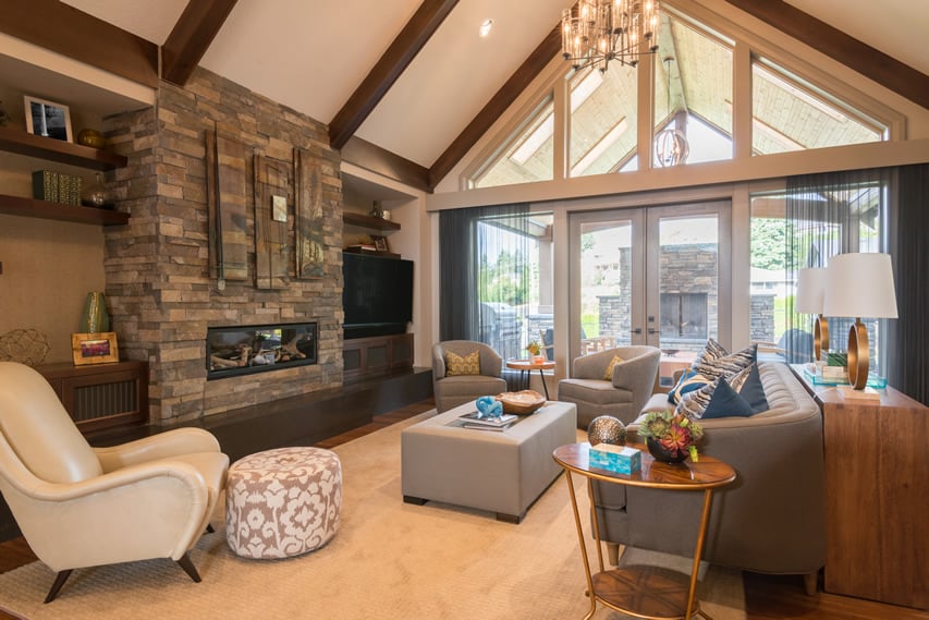 Living room with vaulted ceiling and stone fireplace