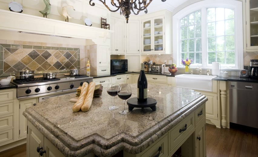 Island with wine glasses and bread on top of double edged counter