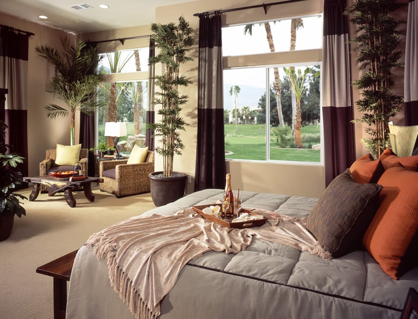 Master bedroom with tropical theme wicker chairs