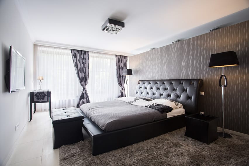Modern apartment bedroom with leather upholstered bed frame