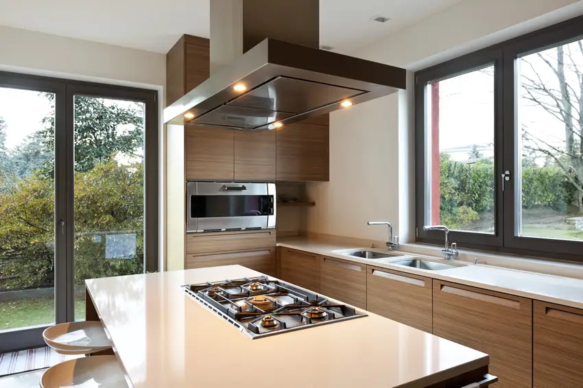Modern home kitchen with brown cabinets and stove in island