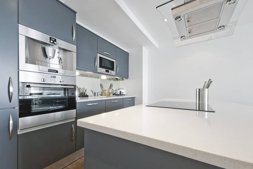 Kitchen with gray cabinets and countertop stove