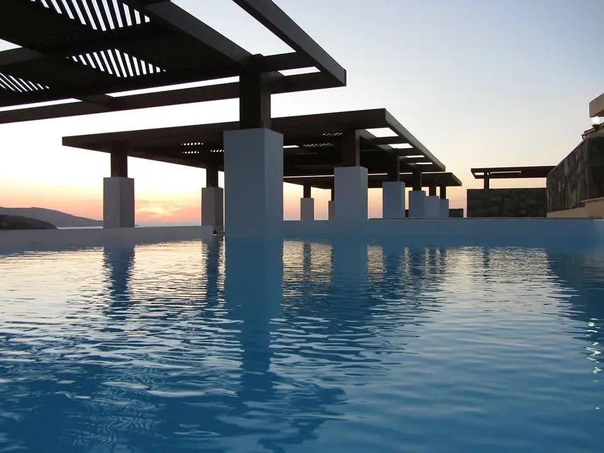 Pool with white pillars overlooking ocean