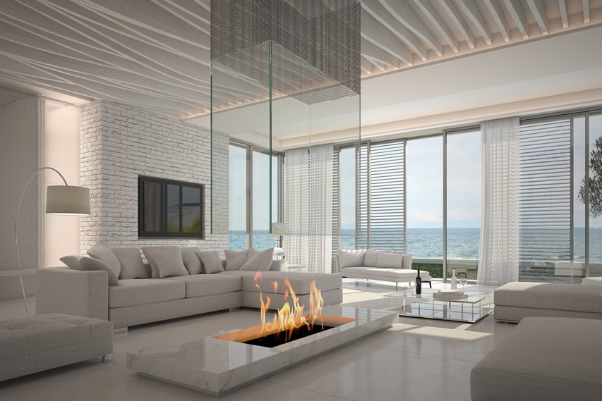 Modern white living room with firepit and ocean view