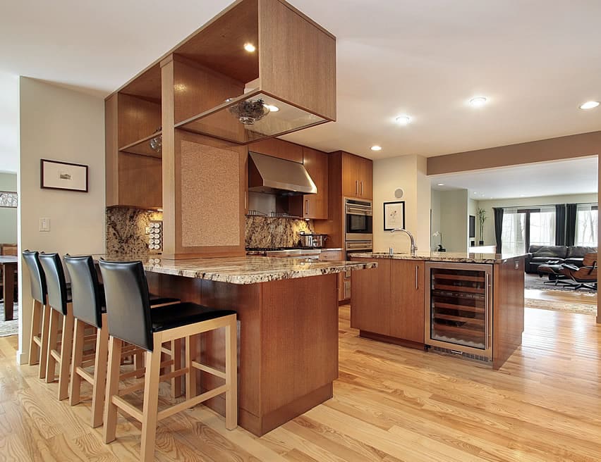 Kitchen with brown modular cabinets and upholstered chairs